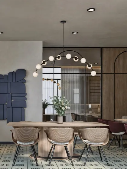 Office design goes beyond desks. It's about creating spaces for people to connect and recharge. This render of an office café features light wood, patterned floors, and modern lighting to create a relaxed vibe for proper downtime.