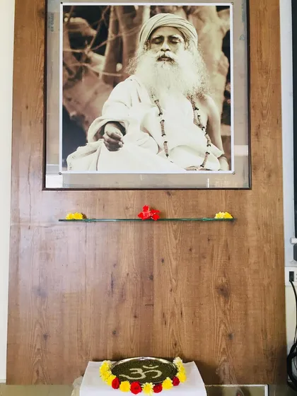 The altar at my studio, with a picture of Sadhguru and the symbol of Aum. For me, being a teacher is an extension of being a volunteer. It is about offering a powerful tool with a sense of devotion and faith in the process.