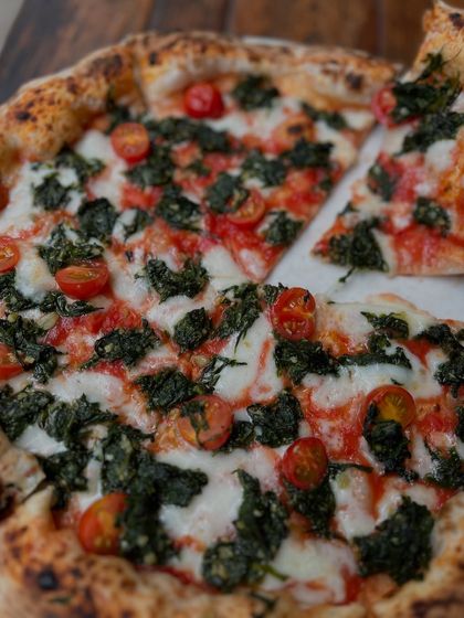 A slice of our Spinach & Garlic pizza is gone, but there's plenty more to enjoy.