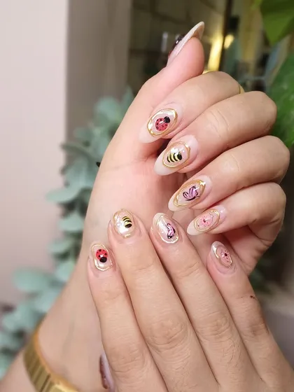 The almond shape of the nails provides the perfect canvas for these adorable, hand-painted characters.