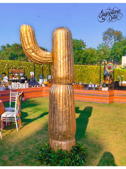 A giant golden cactus prop served as a bold and glamorous statement piece for the Mexican-themed event.