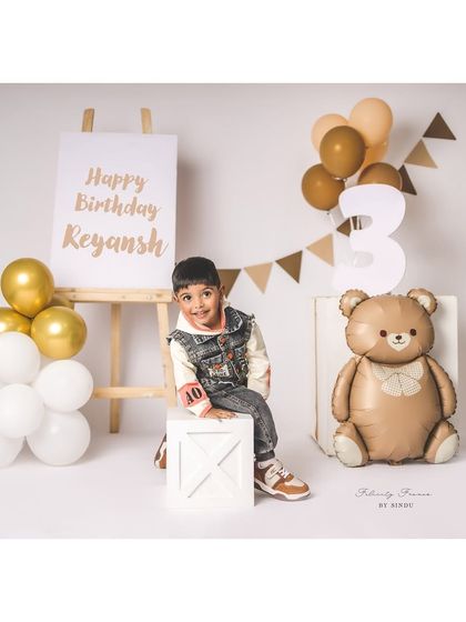 A cool and confident three-year-old posing for his birthday pictures. The teddy bear theme is a classic for a reason!