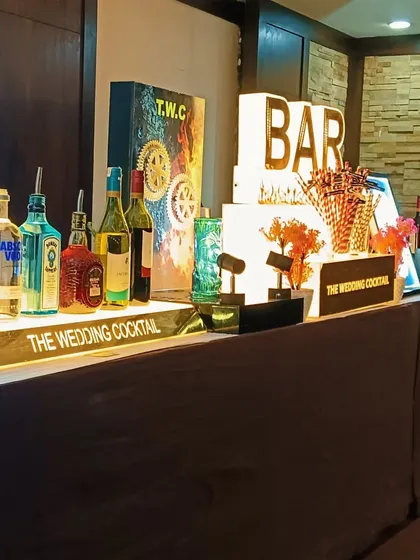 A display of premium liquor on our illuminated bar shelf, with custom branding and decor elements.
