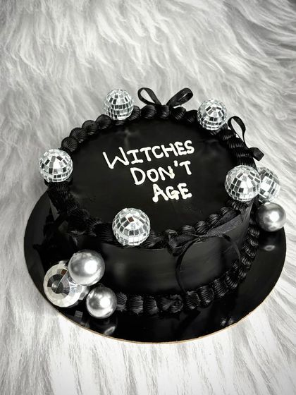When a client gives me their full confidence, beautiful cakes are born. This all-black cake with the message "Witches Don't Age" and mini disco balls is for the queen who stays forever fabulous.