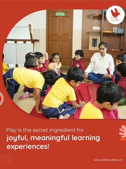 Play is the secret ingredient for joyful, meaningful learning experiences. Here, children are engaged in a group activity on the floor, learning social skills and problem-solving in a fun, natural way.