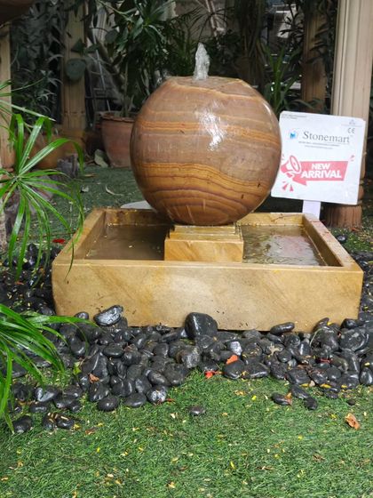 This modern sphere fountain is a self-contained unit, perfect for a patio or garden. The water recirculates from the tank, making it low-maintenance.