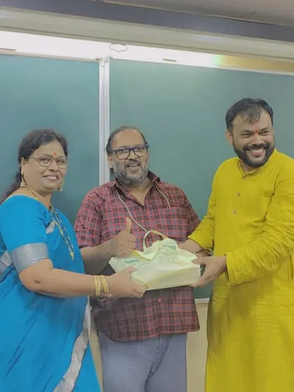 Prof. Parab and a senior teacher present a Diwali gift to a male faculty member, acknowledging the contribution of every team member.