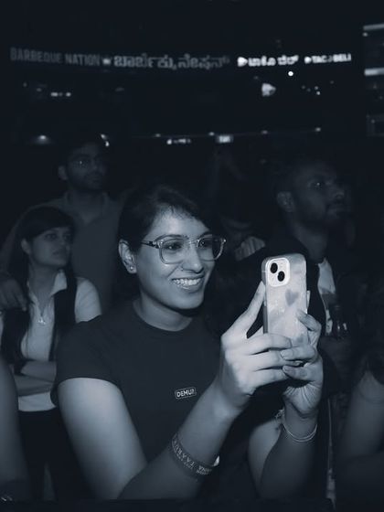 A fan captures the moment on her phone, part of a sea of smiling faces. The ultimate goal of my events is to create moments of joy and connection that people want to remember and share.