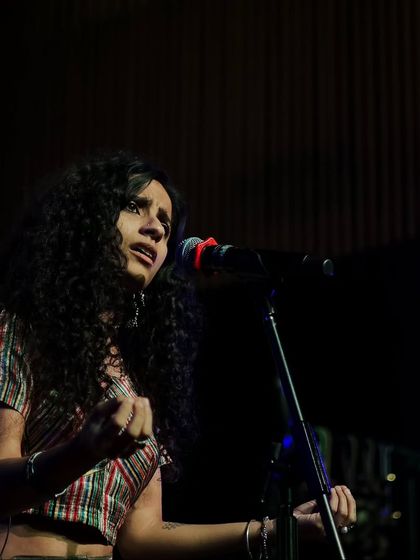 A powerful shot of singer Bawari Basanti mid-performance. Her expressive face and posture convey the passion and emotion she brings to her music, typical of the artists we feature.
