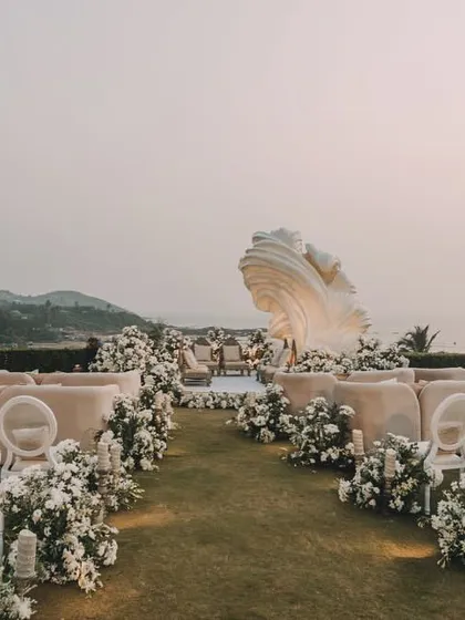 Sometimes, the most powerful statement is made by complementing the natural beauty of a location. For this ivory sundowner wedding, we created a sculptural, artistic mandap backdrop inspired by Picasso, letting the chaos of art take shape against the serene backdrop of the sea and sand.