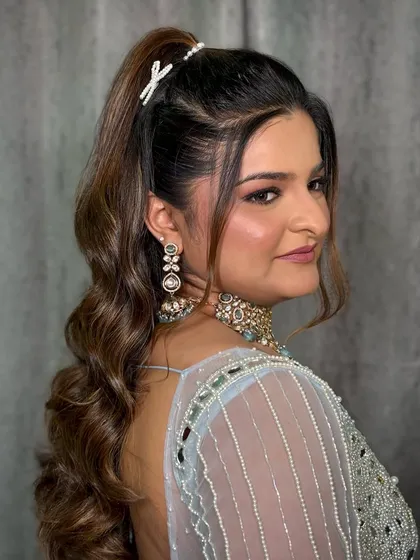 Another view of the look, highlighting the elegant makeup and the beautiful pastel blue outfit.