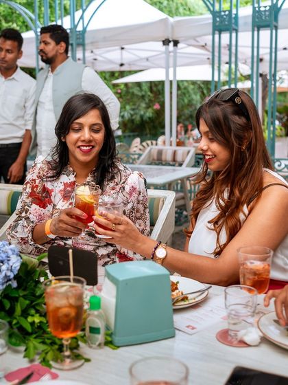 Friends clinking glasses at our Amalfi Sunday Brunch, an afternoon soaked in celebration.