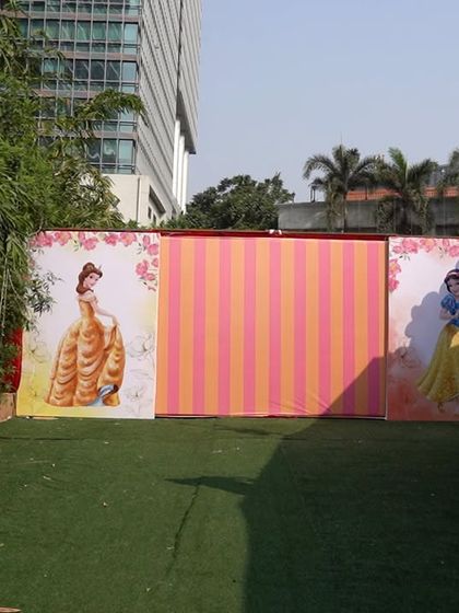 Disney Princess banners and backdrops set up in the outdoor party space.