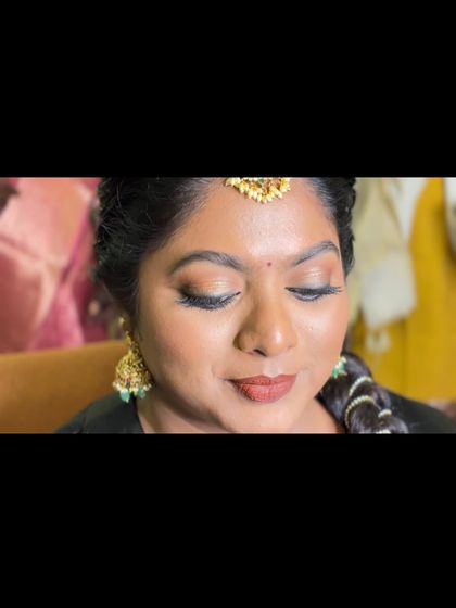 A close-up of Dr. Preetha's smokey gold eyes for her Pondicherry muhurtham. This look is perfect for brides who want defined eyes that are not overpowering.