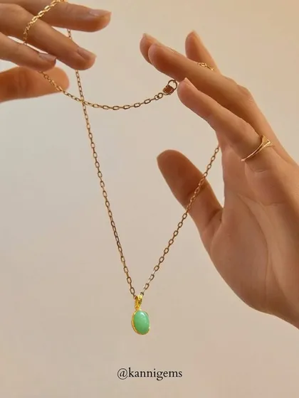 Minimal yet meaningful. This delicate gold chain with a soft green stone pendant is for those who find beauty in simplicity. It is the kind of timeless piece you will reach for every day.