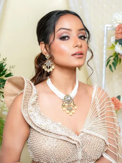 Soft, dainty, and modern. This look is all about an ethereal glow, perfect for a reception or engagement. The makeup is luminous, with a focus on shimmering eyes and dewy skin.