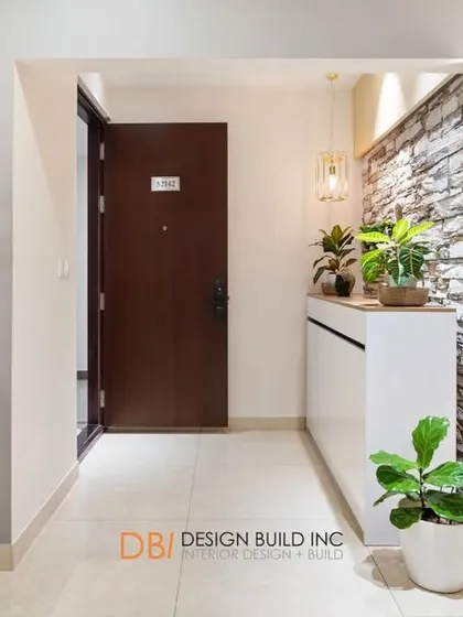 A wider view of the foyer, showing its relationship to the bar and dining area. A slatted wooden partition provides a visual screen while maintaining an open and connected feel.