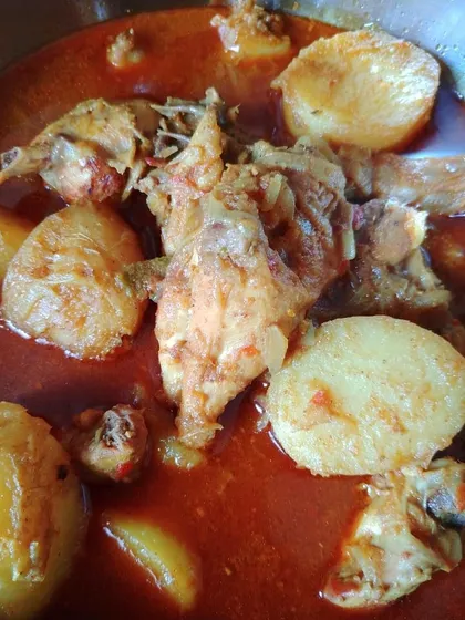 This is comfort food at its best. Murgir Laal Jhol, a light chicken curry with ground spices and, of course, big chunks of potato that we Bengalis love so much.