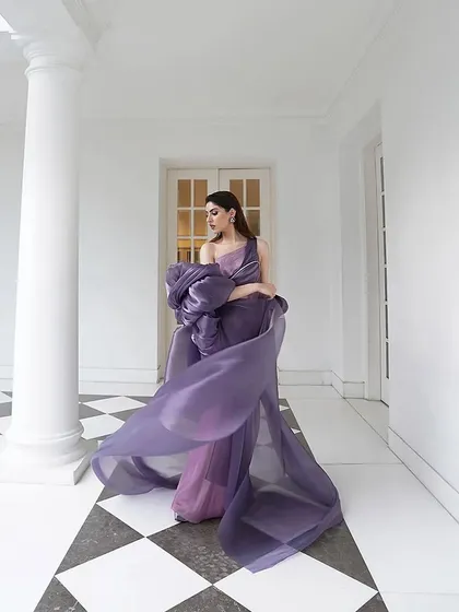 The flowing fabric and dramatic sleeves of this purple Amit Aggarwal gown create beautiful movement. It's a perfect example of wearable art, styled for maximum impact.
