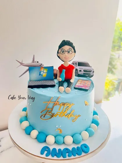 A personalized cake showing all of Anang's favorite things: travel, cars, and his laptop.