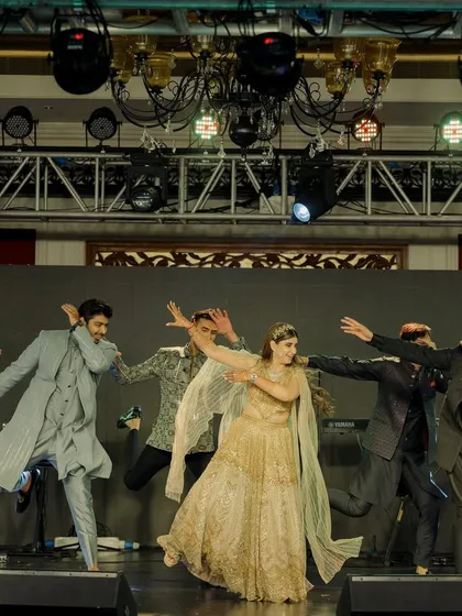 The bride joins the groom's squad for a high-energy dance number. We love creating performances that bring both sides of the family together.