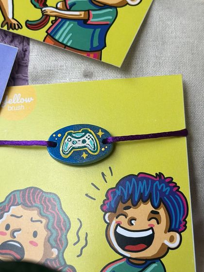 A close-up of the gamer-themed Rakhi, a perfect modern twist on a traditional gift.