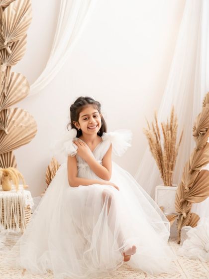 A sweet, smiling portrait of a girl in our boho-chic setup, looking relaxed and happy.