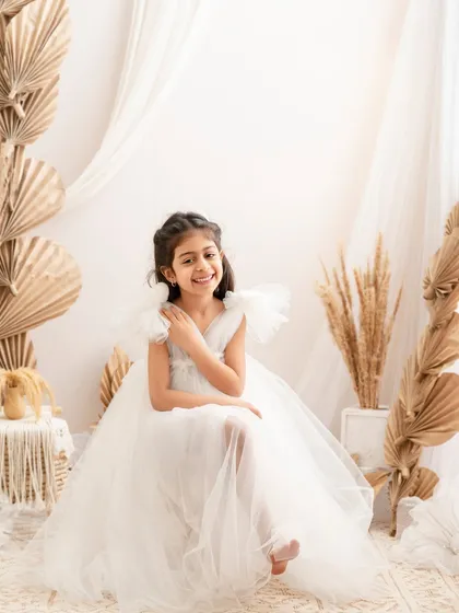A sweet, smiling portrait of a girl in our boho-chic setup, looking relaxed and happy.