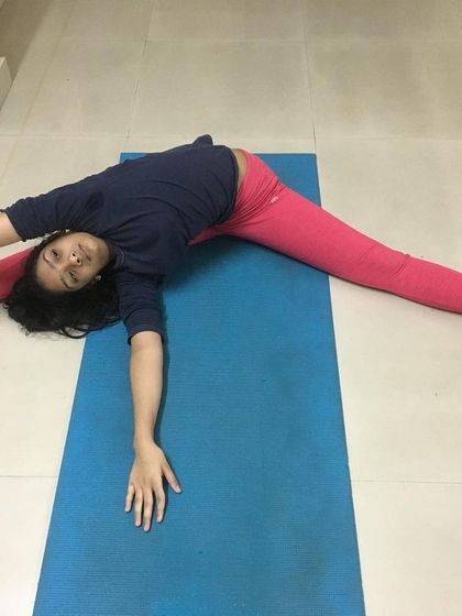 The young student tries another variation, reaching for the wall.