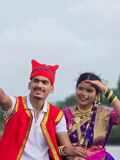 A fun and candid shot from a pre-wedding shoot. The groom-to-be is wearing a traditional Koli-style outfit with a red waistcoat, which we provided for rent.