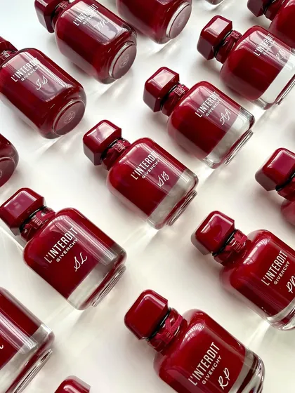 A collection of the finished Givenchy bottles, each with unique initials. This showcases the consistency and elegance I deliver for brand events.