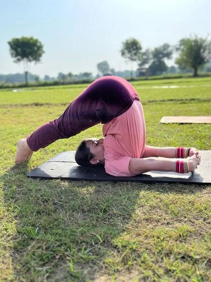 Practicing Halasana, or Plow Pose, in the fresh air. The open space adds a feeling of freedom to the practice.