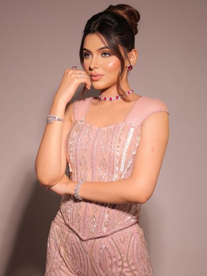 Embracing the corset trend with a touch of timeless elegance. This blush pink, fully embellished sharara set with cap sleeves brings a blend of modern allure and classic charm.