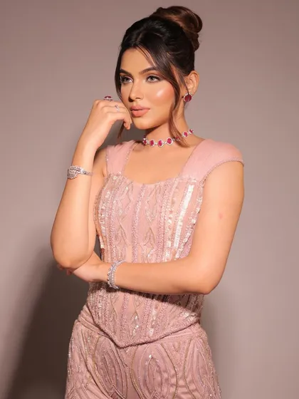 The corset trend, reimagined with timeless elegance. This blush pink, fully embellished sharara set with sleeves brings a blend of modern allure and classic charm.