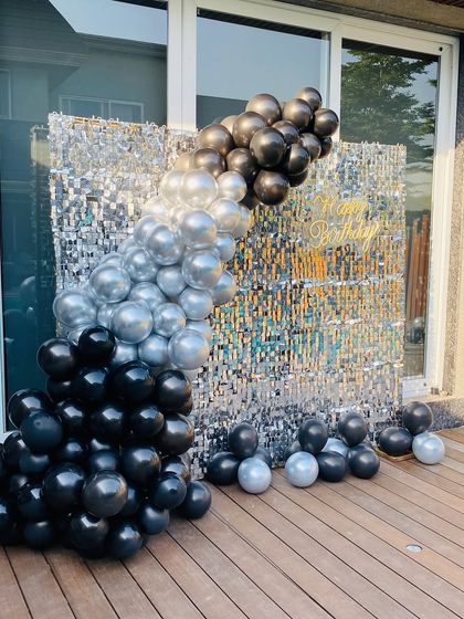 A close-up of the black and silver balloon garland against the shimmer wall.