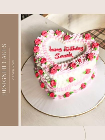 A vintage-inspired heart-shaped cake with delicate pink buttercream roses, perfect for a romantic birthday.
