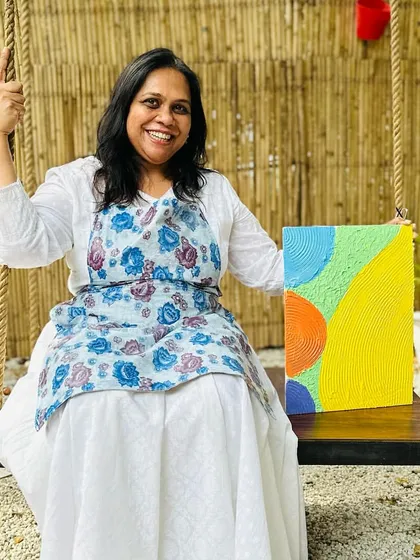 The pure joy of creation! This participant is beaming as she holds up her colorful abstract artwork. The bright, cheerful colors she chose perfectly reflect the happy vibe of the workshop.