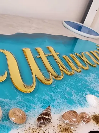Work in progress on another ocean theme nameplate. The golden acrylic name "Athwani's" looks stunning against the blue resin waves.