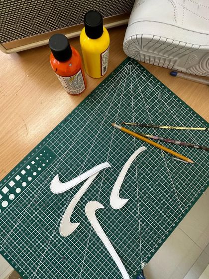 Behind the scenes of a custom project. Here I'm cutting out stencils for the swooshes.