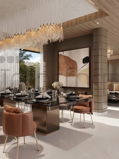 This dining area is a symphony of style, designed as part of an open-plan living space. The long, cascading chandelier defines the dining zone, while the mix of leather and fabric chairs adds textural interest.