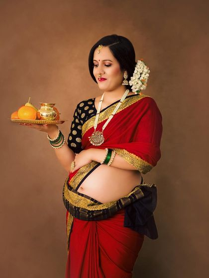 Another beautiful pose from our Raja Ravi Varma inspired series. The traditional attire, jewelry, and props come together to create a piece of living art.