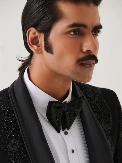 A close-up of the custom-embroidered bow tie that accompanies our Nazaakat tuxedo, showcasing our attention to every detail.