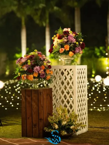 Another view of the floral pedestals, showing how they can be used to define a space or create a beautiful focal point in an outdoor or indoor setting.