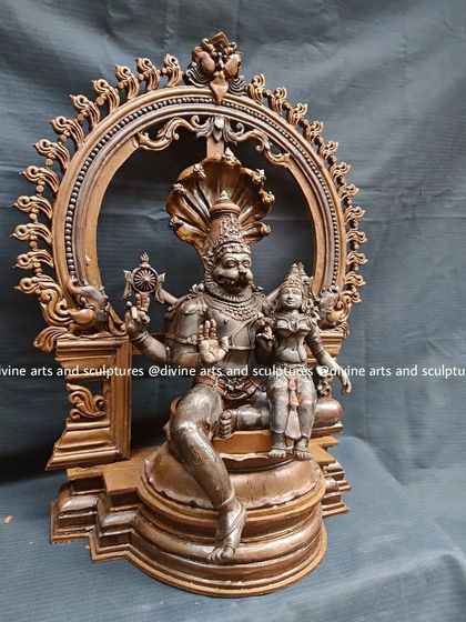 This side view of the Lakshmi Narasimha wax model highlights the depth and complexity of the sculpture, from the serpent hood to the detailed base.