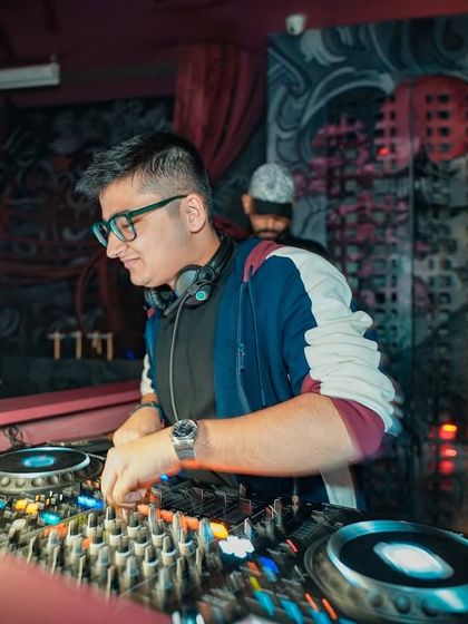 A clear shot of me at the controls, concentrating on the mix against the cool graffiti wall at Takumi.