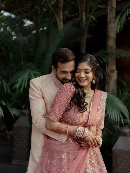 A joyful embrace during Prachi and Shubham's engagement. Her beautiful pink lehenga and his classic sherwani are complemented by their radiant smiles.