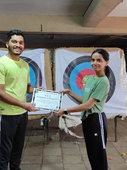 A happy graduate from our July Basic Archery Course receiving her certificate. We congratulate all our students for their hard work and dedication.