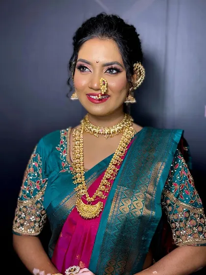 A full view of the Maharashtrian look, showcasing the beautiful saree, the long necklace, and the radiant makeup.