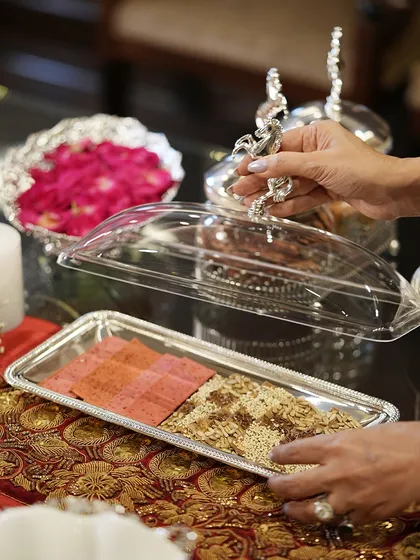 This lidded serving tray is perfect for keeping sweets and savories fresh during a party. The ornate handle adds a touch of regal elegance to the practical design.
