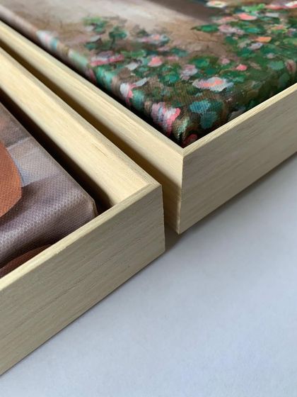 A close-up of the corners of the wooden floater frames, showing the quality craftsmanship and the beautiful texture of the wood.